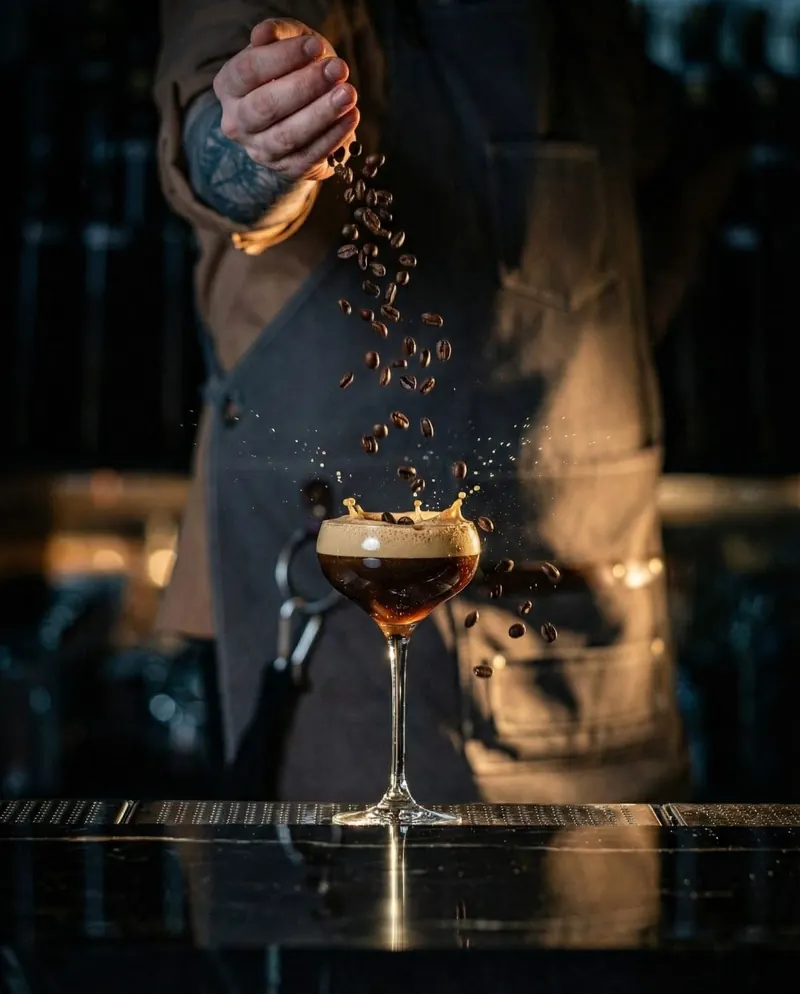 Espresso cocktail with falling coffee beans at the TOGA bar